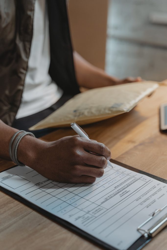 Person writing Down on a Document